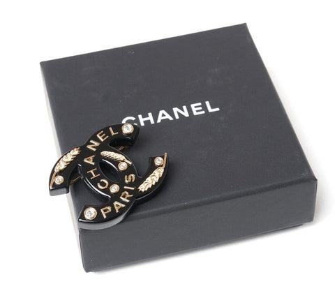 A Black Chanel Brooch featuring a Wheatsheaf design