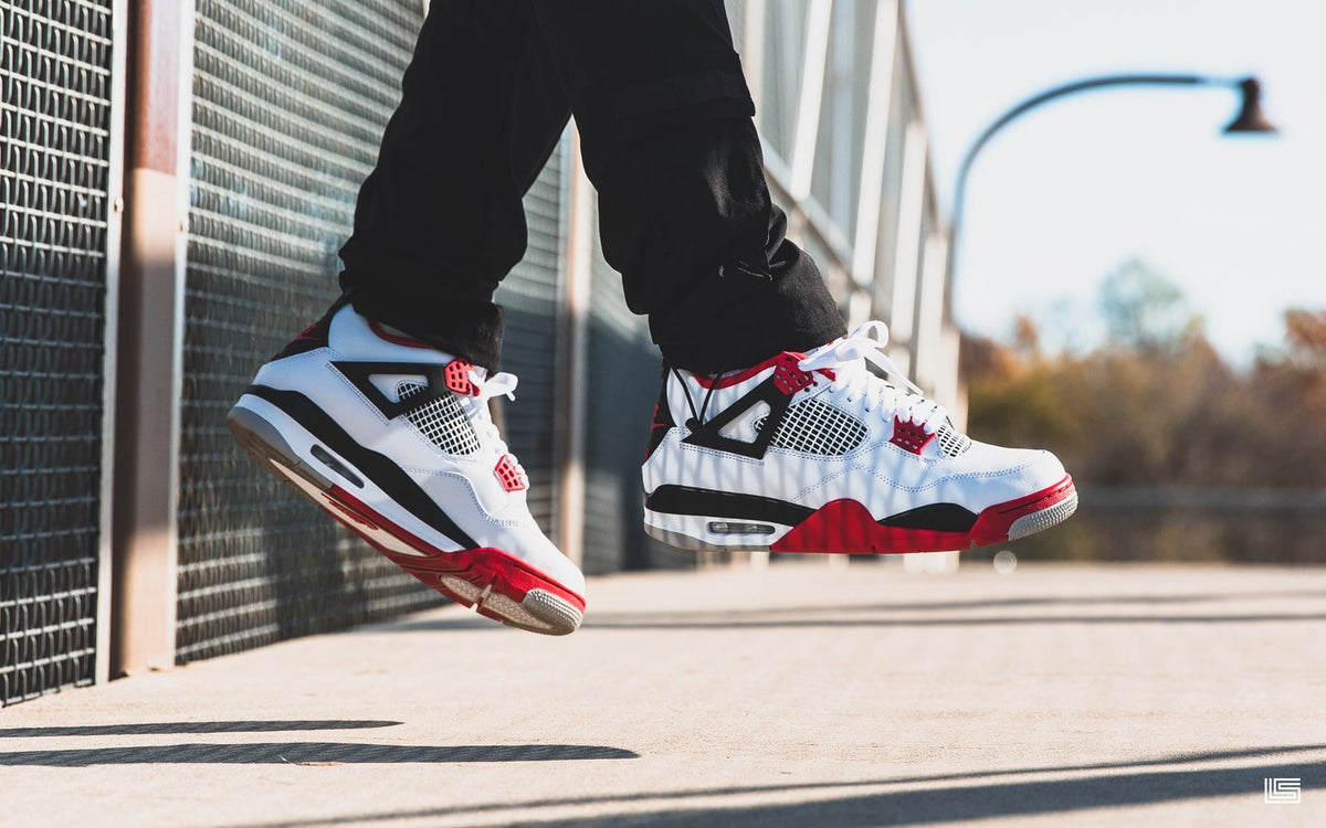 fire red jordan 4 on feet