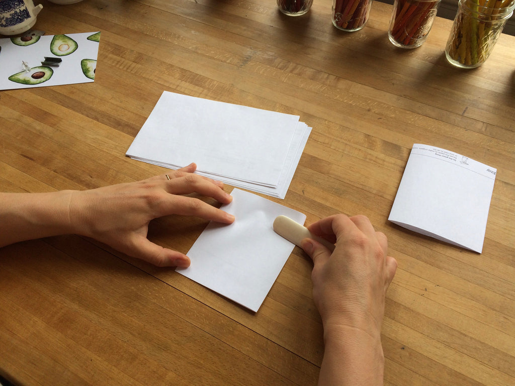 hand folding and creasing paper 