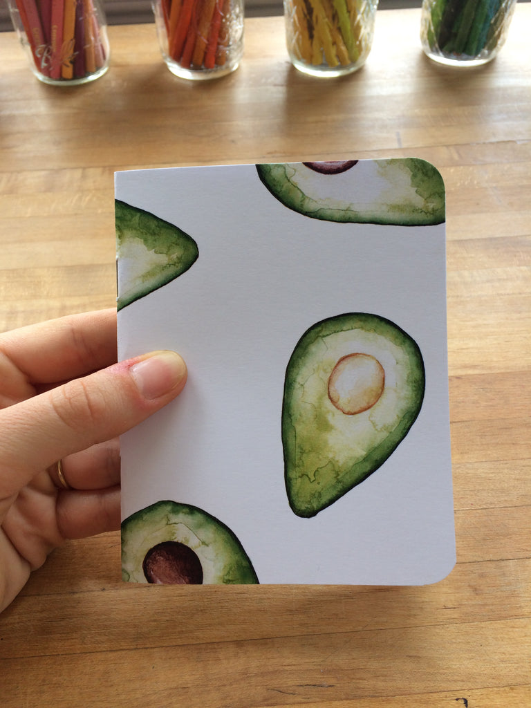 small handmade notebook with an avocado print on the cover