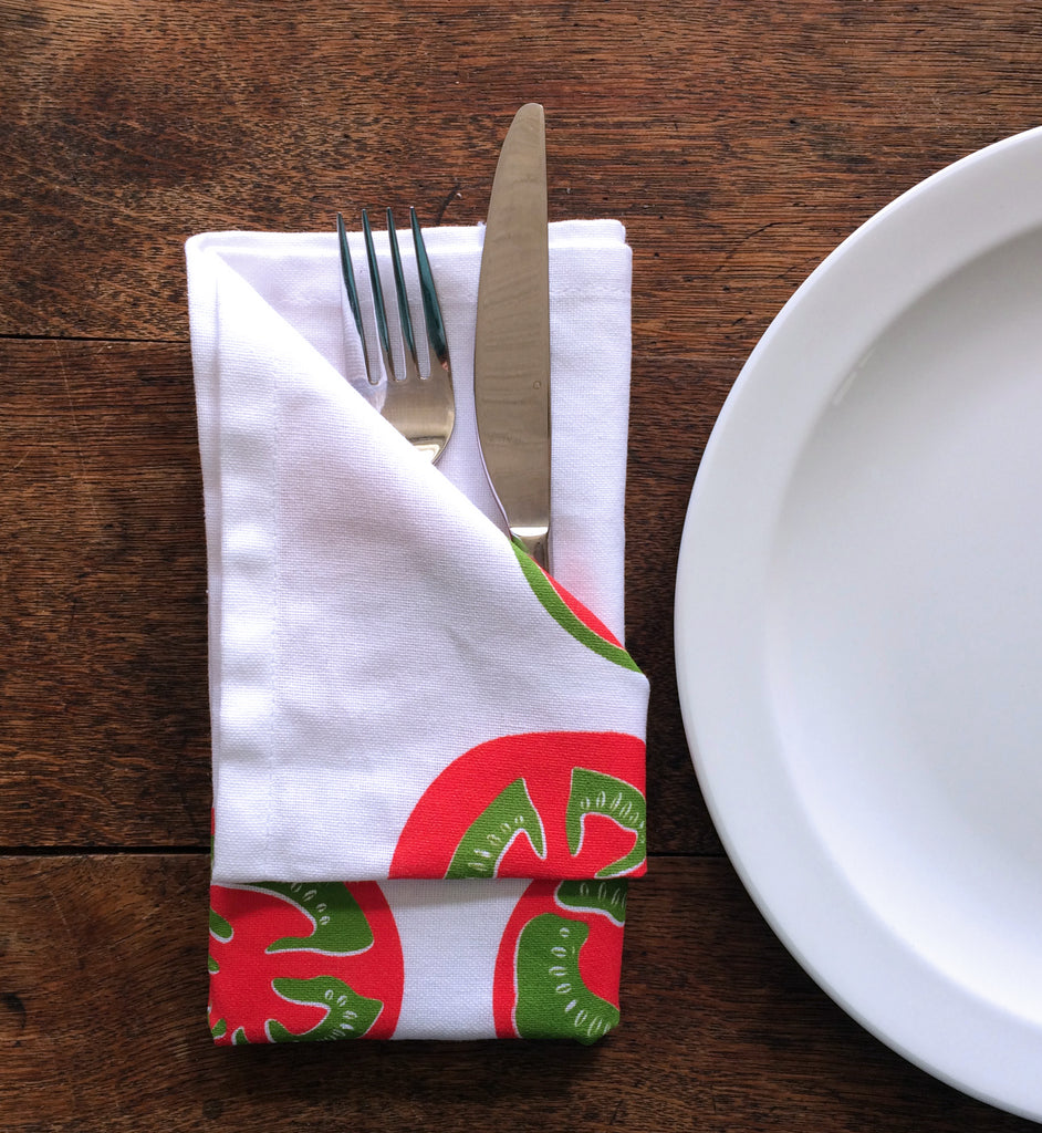 tea towel folded as a napkin with fork and knife