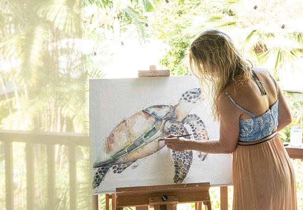 Stephanie Elizabeth painting a turtle on her deck
