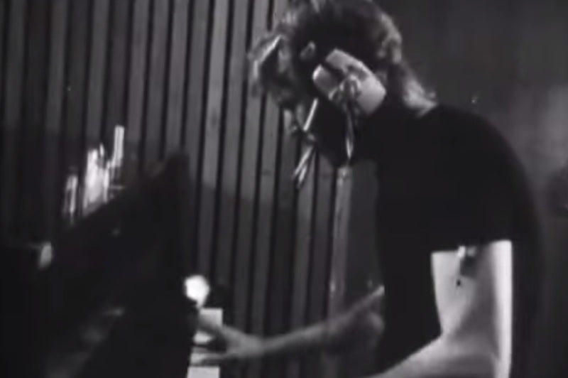 Harry Nilsson smokes a cigarette while recording piano