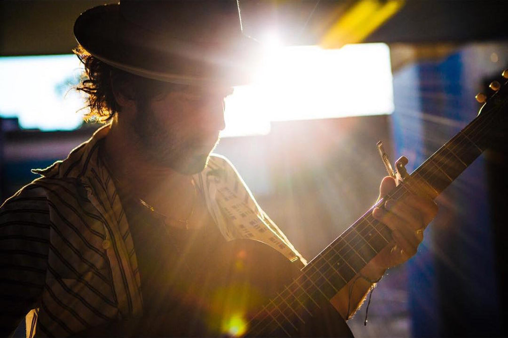Langhorne slim performs with his acoustic guitar and an Indian guitar strap by Original Fuzz