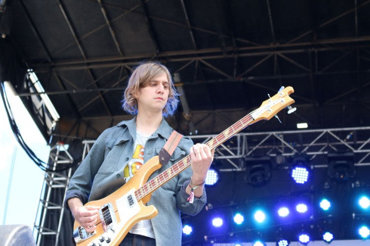 Rob Laasko uses his Peruvian guitar strap on a blonde Rickenbacker bass