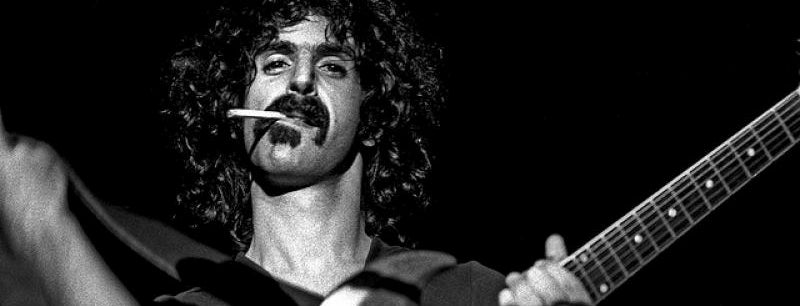 Frank Zappa with a cigarette and guitar