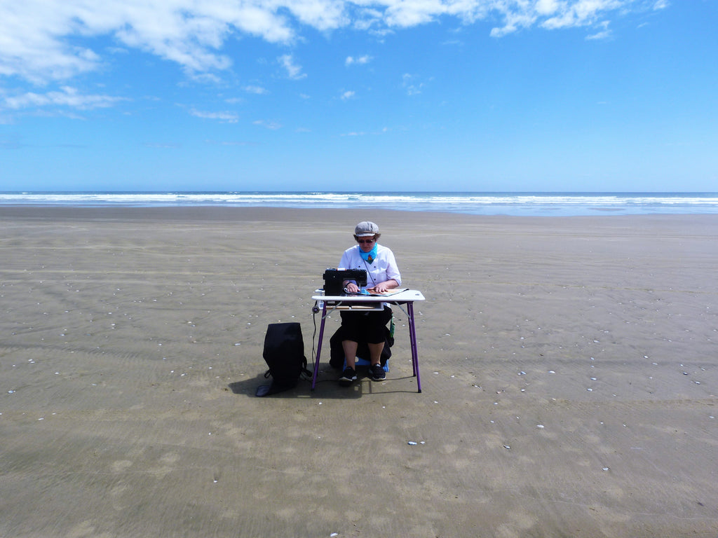 Susan quilting on the beach