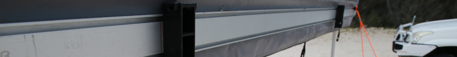 Close up of RacksBrax Holders attached the awning accessory