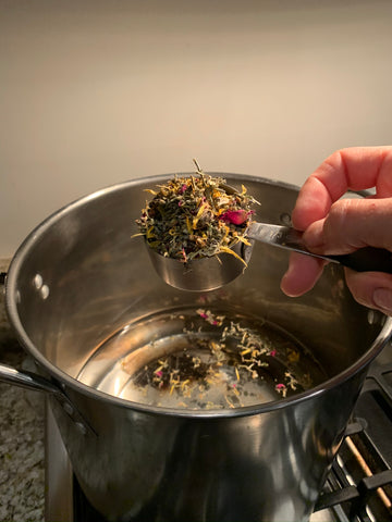 Adding herbs to boiling water