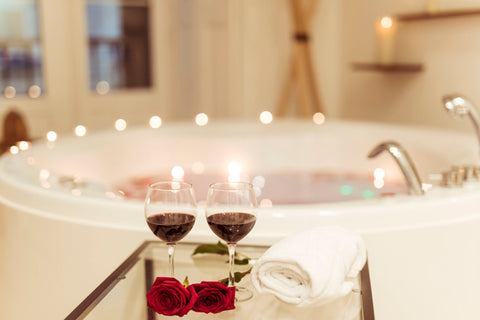 Two glasses of red wine for great skin and a bathtub for a wine bath