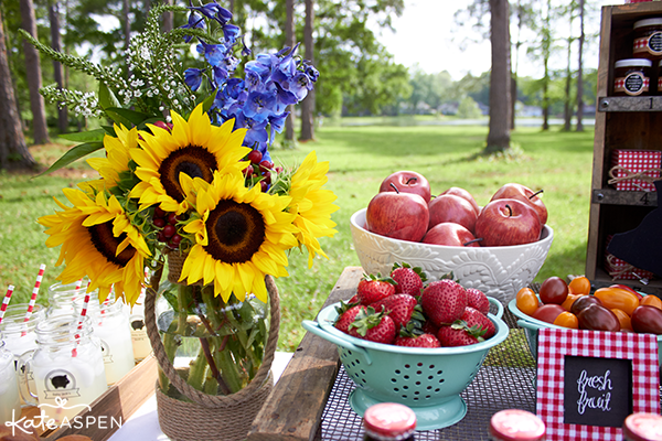 Barbecue picnic table with sunflowers, strawberries and apples
