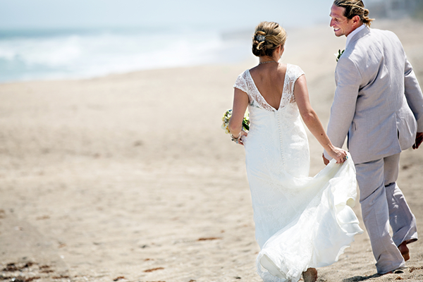 Bride and Groom Walk Down the Beach