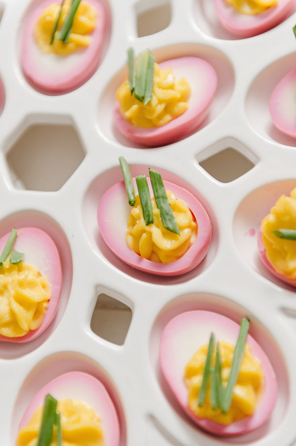 Pink Deviled Eggs add a pop of color to this vintage party menu | A Retro Flamingo Engagement Party | Two Prince Bakery Theater | Marc Edwards Photographs