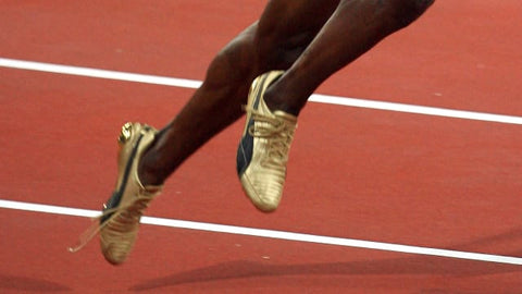Usain Bolt running with untied shoelaces