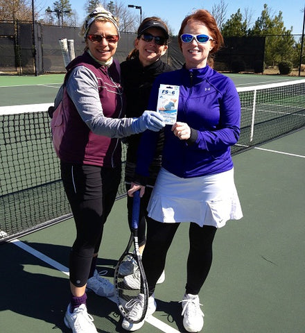 Group of women on the tennis court holding up the OrthoSleeve FS6