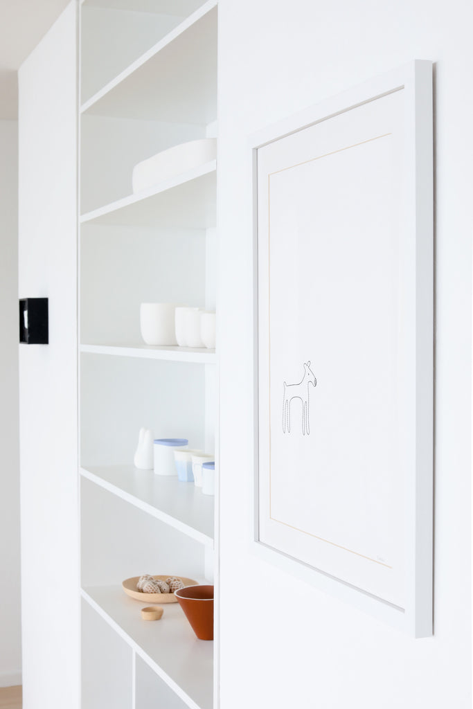 Dog artwork by K Studio in modern, minimalist white house with open shelving in Faunamade blog post