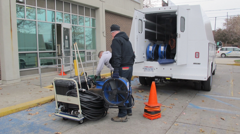 Pest control professionals unloading a self-contained power bed bug heat treatment truck.