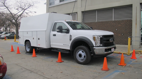 Self-Contained power truck used for killilng bed bugs with electric bed bug heaters parked in front of a high rise residential building