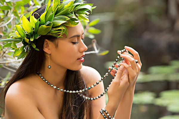 holding pearl necklace creating a pearl