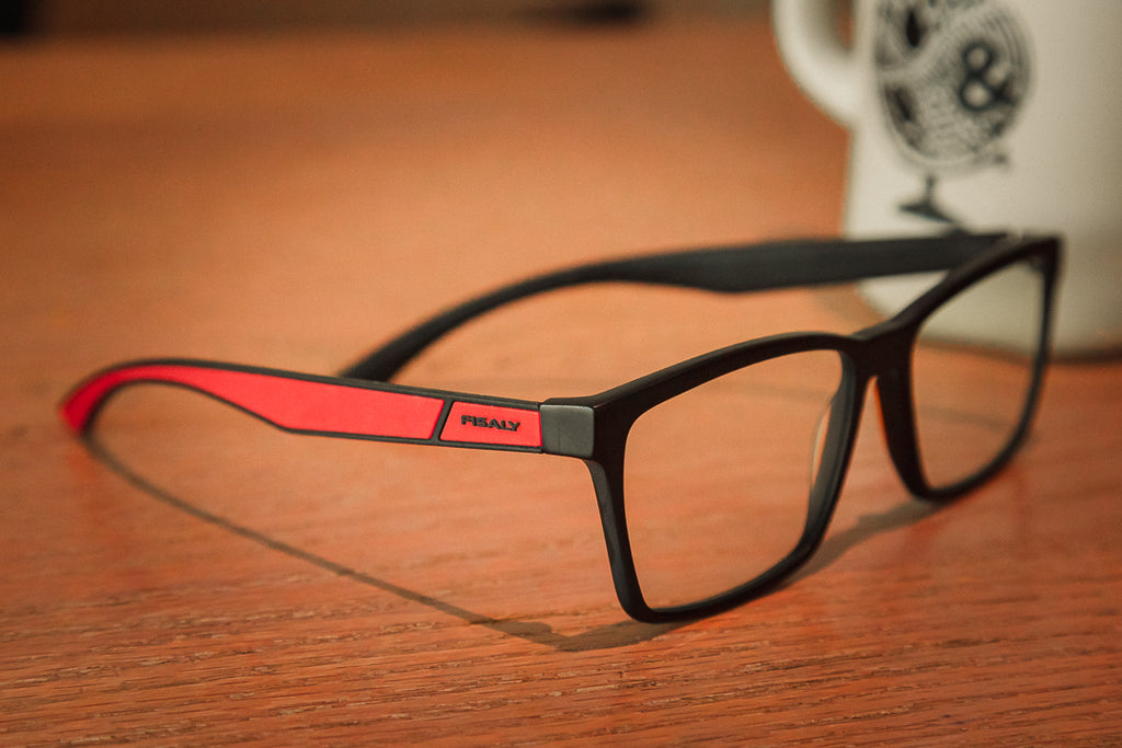 Fisaly prescription eyeglasses on table top with coffee beside it 