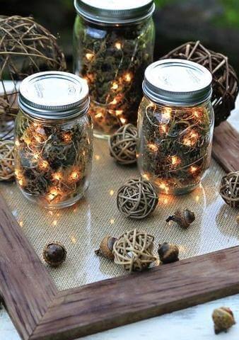 seasonal decoration of pine cones and fairy lights in glass jars