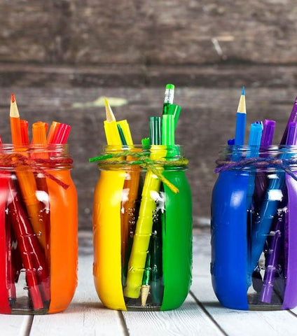 colouring pencils and craft supplies in rainbow glass jars 
