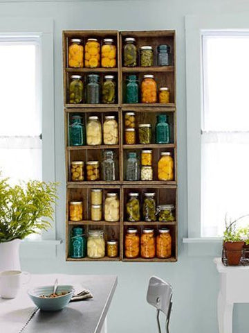 shelf full of glass jars used for canning and preserving foods 