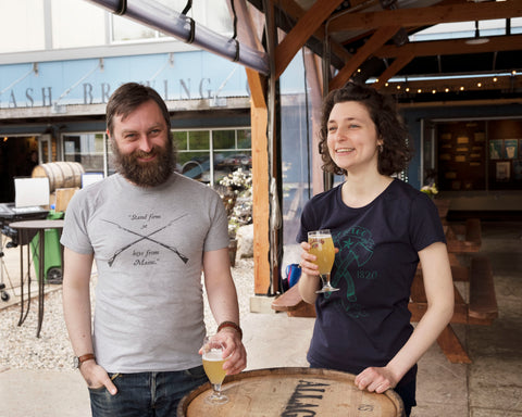 Alex and Emma sport Loyal Citizen Clothing t-shirts in Allagash brewing's tasting room.
