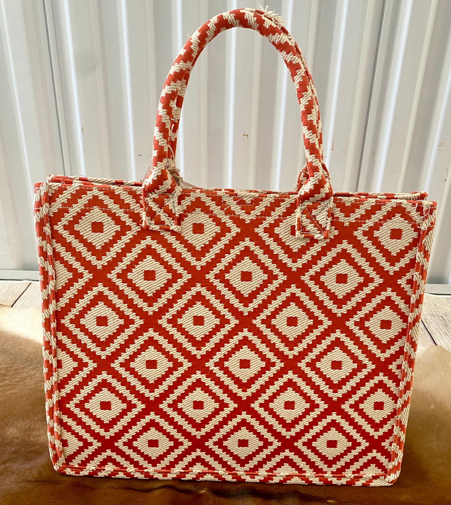 Perfect for summer coral color geometric patterned tote bag. The essential beach and vacation tote purse that will keep you stylish and kept together. Size : 14" X 6" X 11.5" Material : 100% PolyesterThe Anglo Coral Geometric Patterned Large Tote Bag