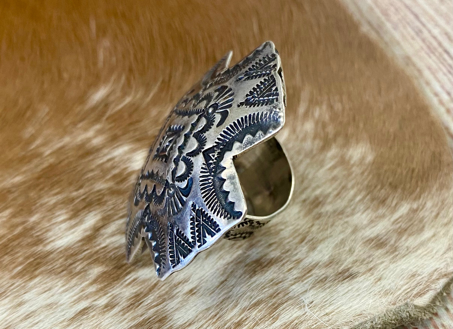 Large native made sterling silver cross adjustable ring statement piece. Adjustable to fit your ring size by pushing inward on the adjustable band. Stamped sterling and signed “VJP” by Native American artist and silversmith Vincent J. Platero. This sterling silver ring is unique and will make for a beautiful addition to anyones jewelry wardrobe. Size: 1.5” Inch Length X 1.5” Inch Width Signed: YES "VJP" Hallmark/Artist: Vincent J. Platero