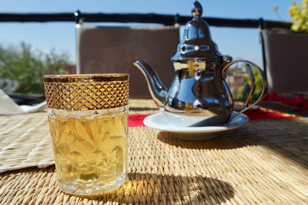 Fresh mint tea in Marrakech, poured from their icon silver teapots and served in decorative glassware