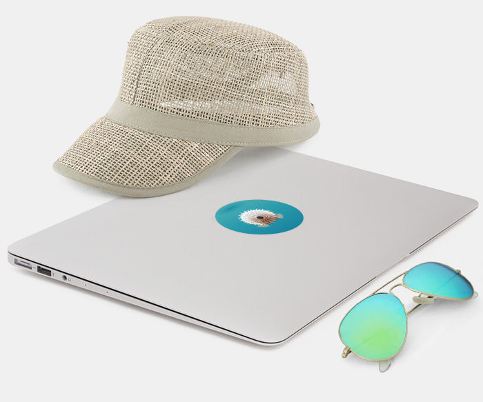 macbook with glowing decal, sunglasses and cap