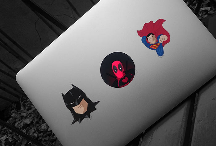 glowing superhero macbook stickers on a macbook