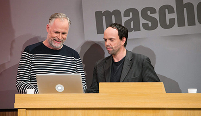 comedian due maschek presenting with a glwoing tabtag on their macbook