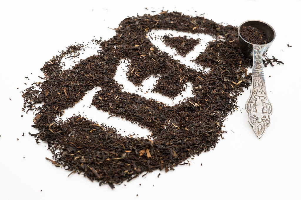Tea written with loose tea leaf