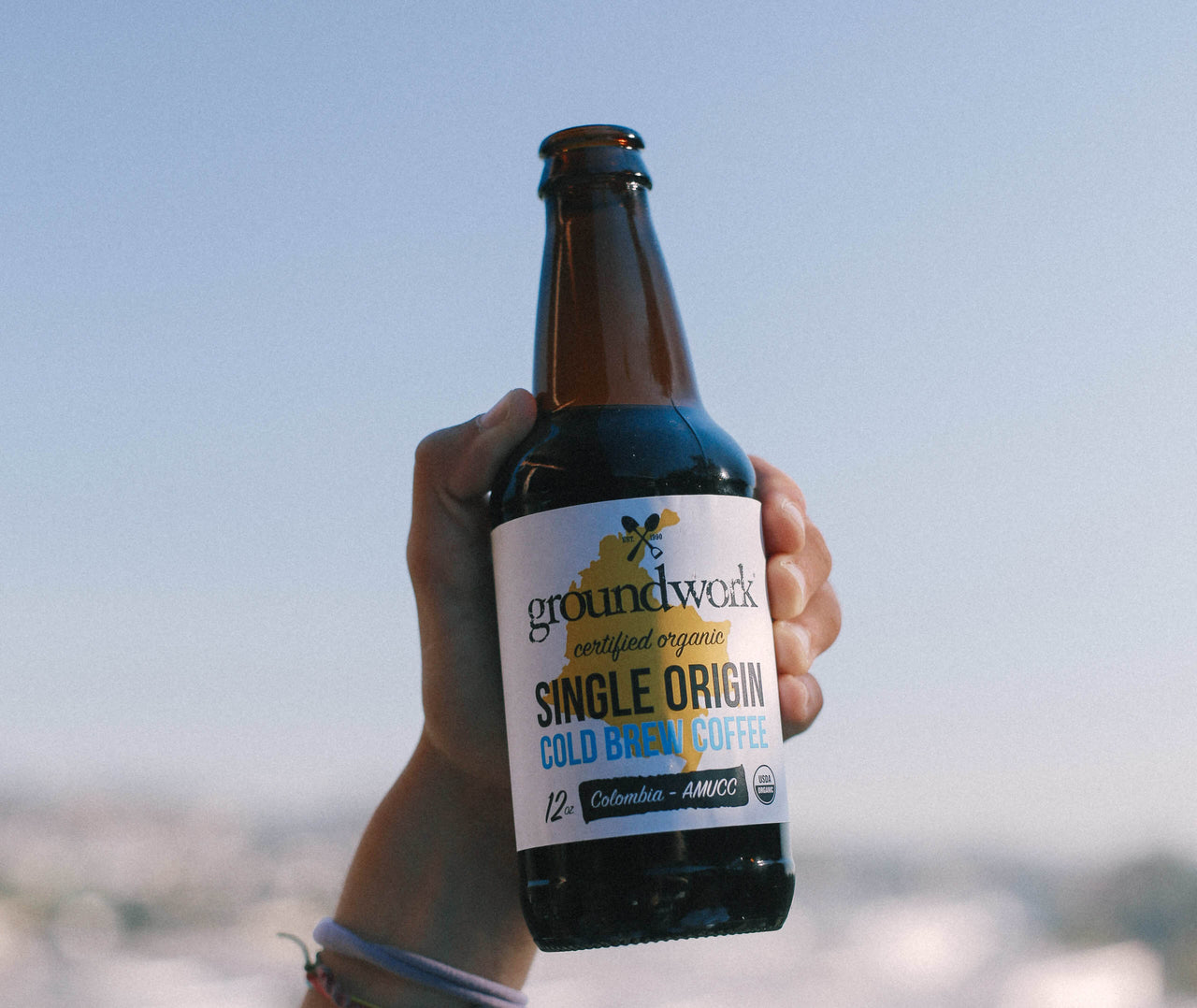 hand holding up Groundwork Single Origin Cold Brew