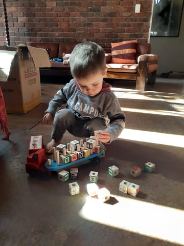 boy playing with his alphabet truck