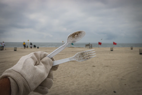 Plastic utensils on beach in New York