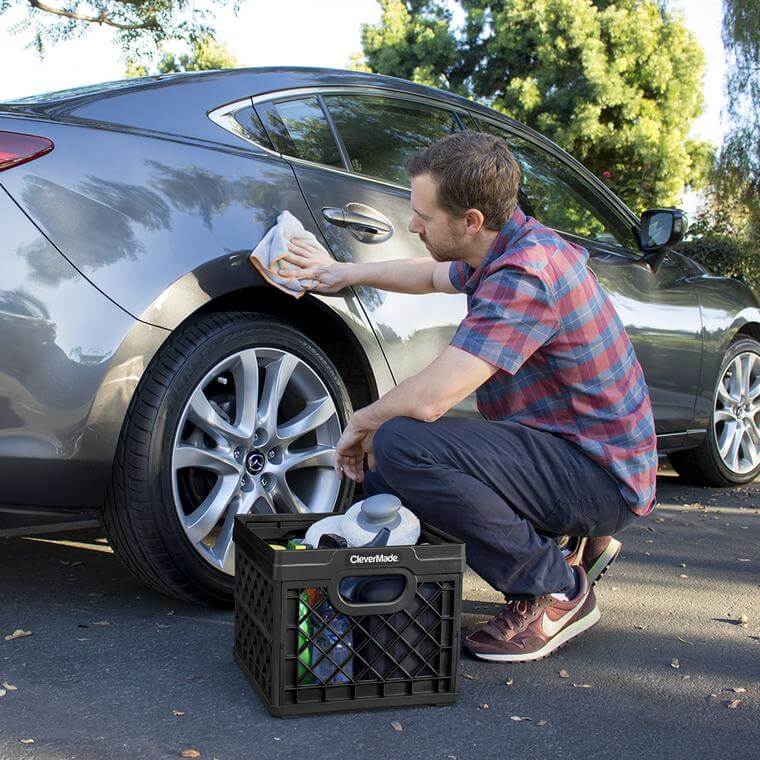 Man washing his car with a supplies in a CleverCrate® Milk Crate in Black
