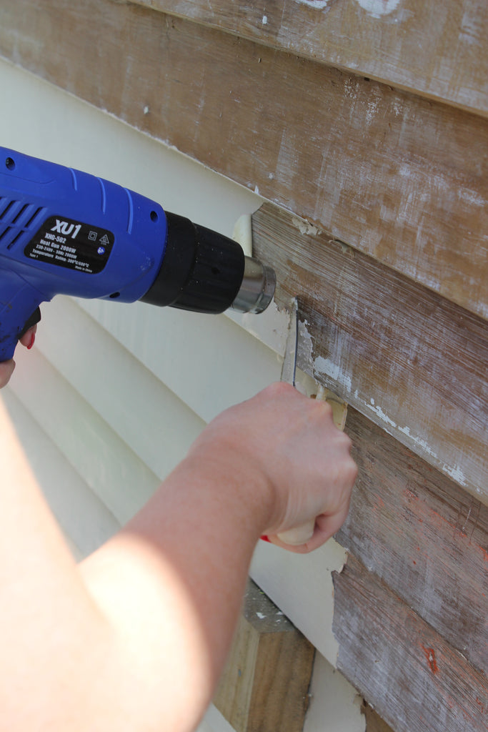 Stripping paint off of house with heat gun