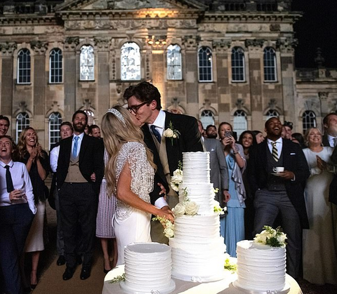 Ellie Goulding wearing Ralph & Russo caplet over a white skirt on her wedding day