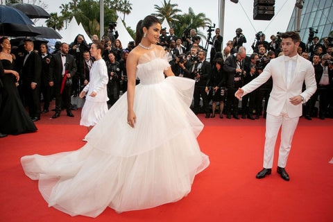 Priyanka Chopra alongside husband Nick Jonas wearing a George Hobeika wedding inspired gown at Cannes Film Festival