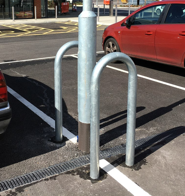 Lamp post protector, street furniture guard, bollard cover for parking lot and traffic safety. Collision protective sleeve for vehicle damage prevention and street lighting.