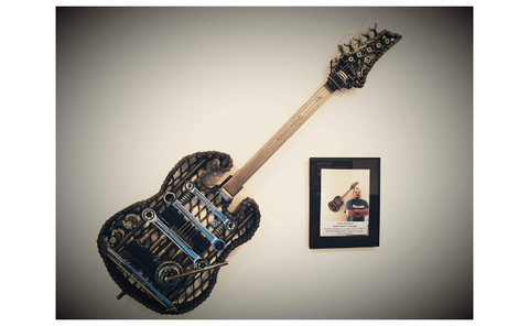 This is a scrap metal guitar that was commissioned on display in the front conference room of the Fastenal Distribution Center in Jessup, PA.
