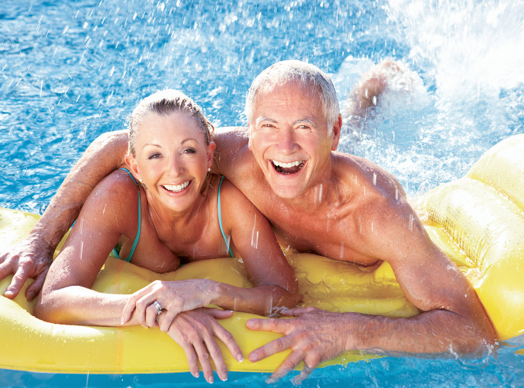 senior couple having fun in swimming pool