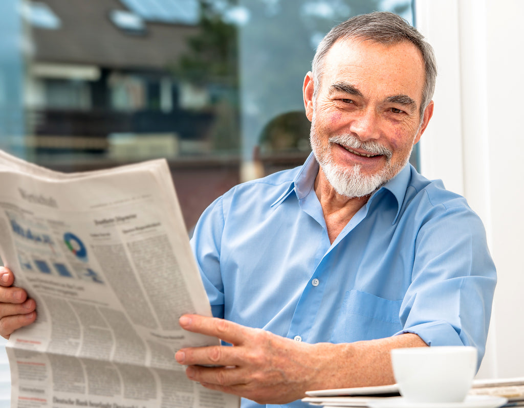 happy older man with newspaper