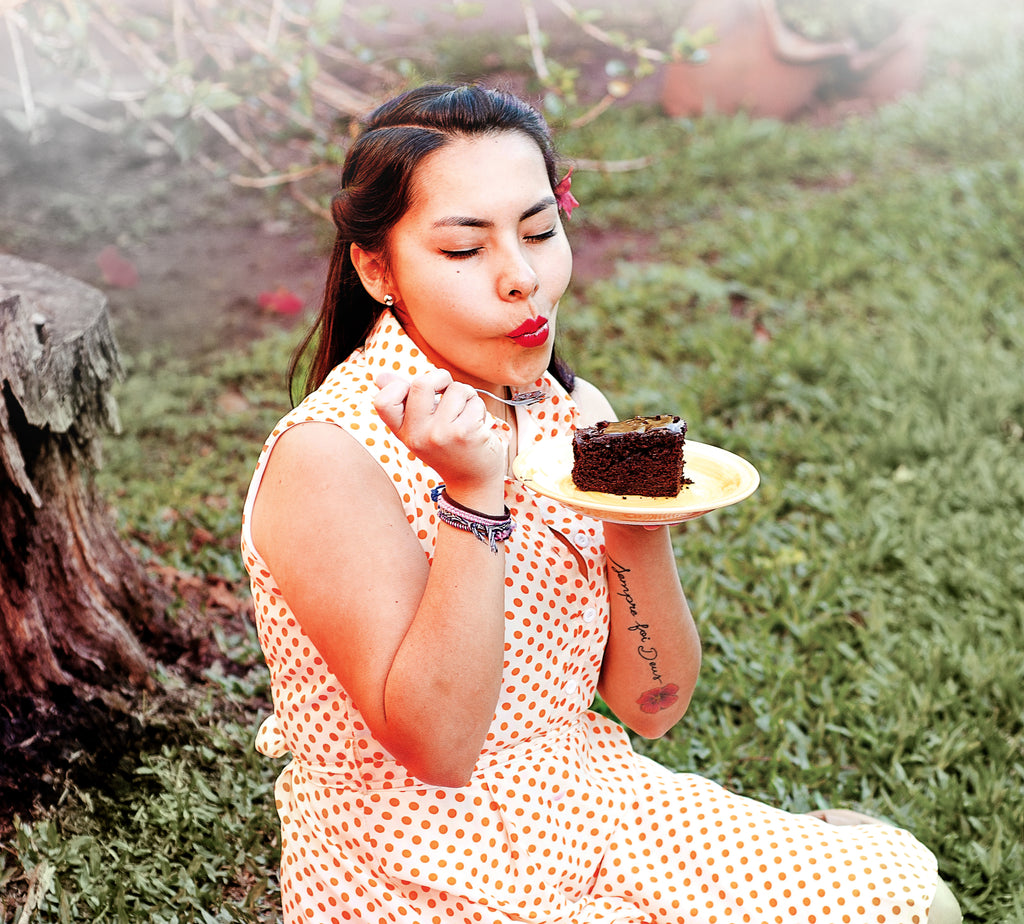woman eating cake outside