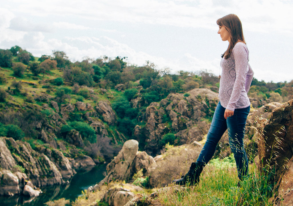 woman standing in mountainous landscape