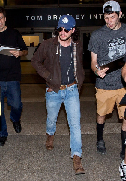 Kit Harrington wearing light wash jeans