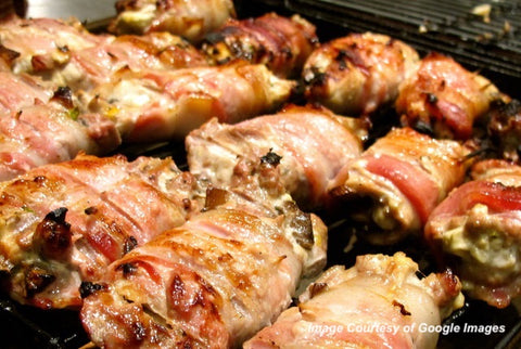 Image of fully cooked pheasant breasts wrapped in prosciutto.